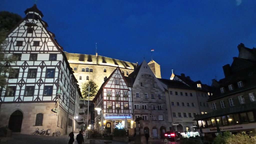 Half-timbered buildings with Nuremberg Castle behind.